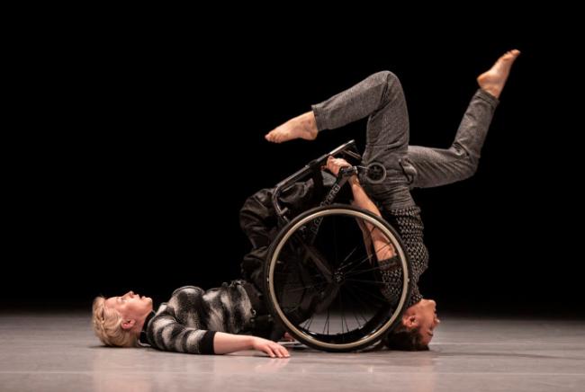 Two professional dancers and a wheel chair on a stage